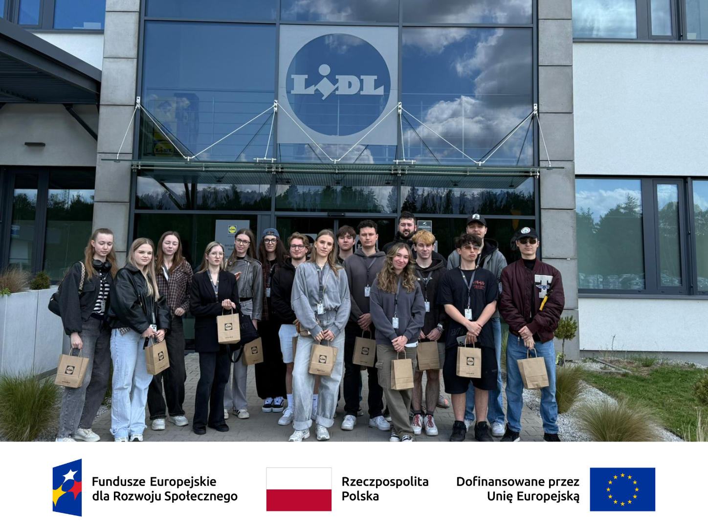 Grupa studentów przed budynkiem firmy